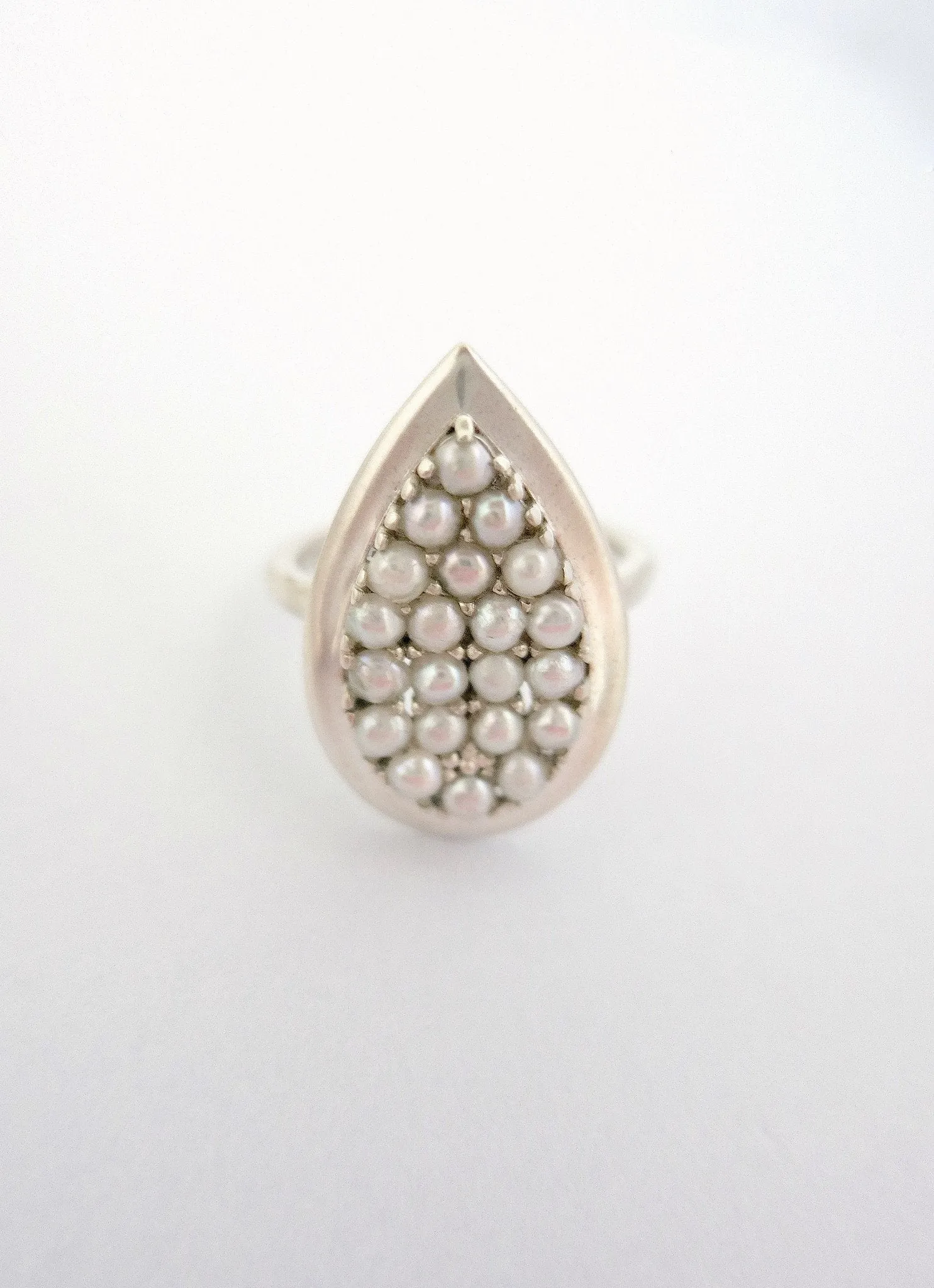 Exquisite, tear-drop shape pearl encrusted ring