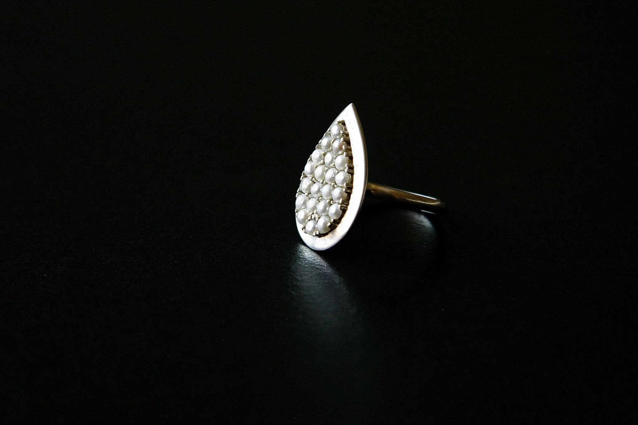 Exquisite, tear-drop shape pearl encrusted ring