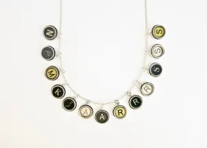 Vintage French typewriter key pendant on a silver snake chain
